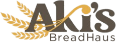 TrailHEAD Café branding logo with a yellow fork-and-knife icon, script title, and 'Powered by AKIS BreadHaus' text.
